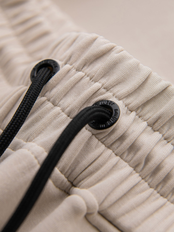 Ombre Clothing Pánske tepláky s rebrovanými manžetami a ozdobným zipsom - pieskové Oblečenie Ombre