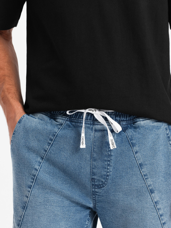 Ombre Clothing Pánske džínsové tepláky s asymetrickým prešívaním modré Ombre Oblečenie